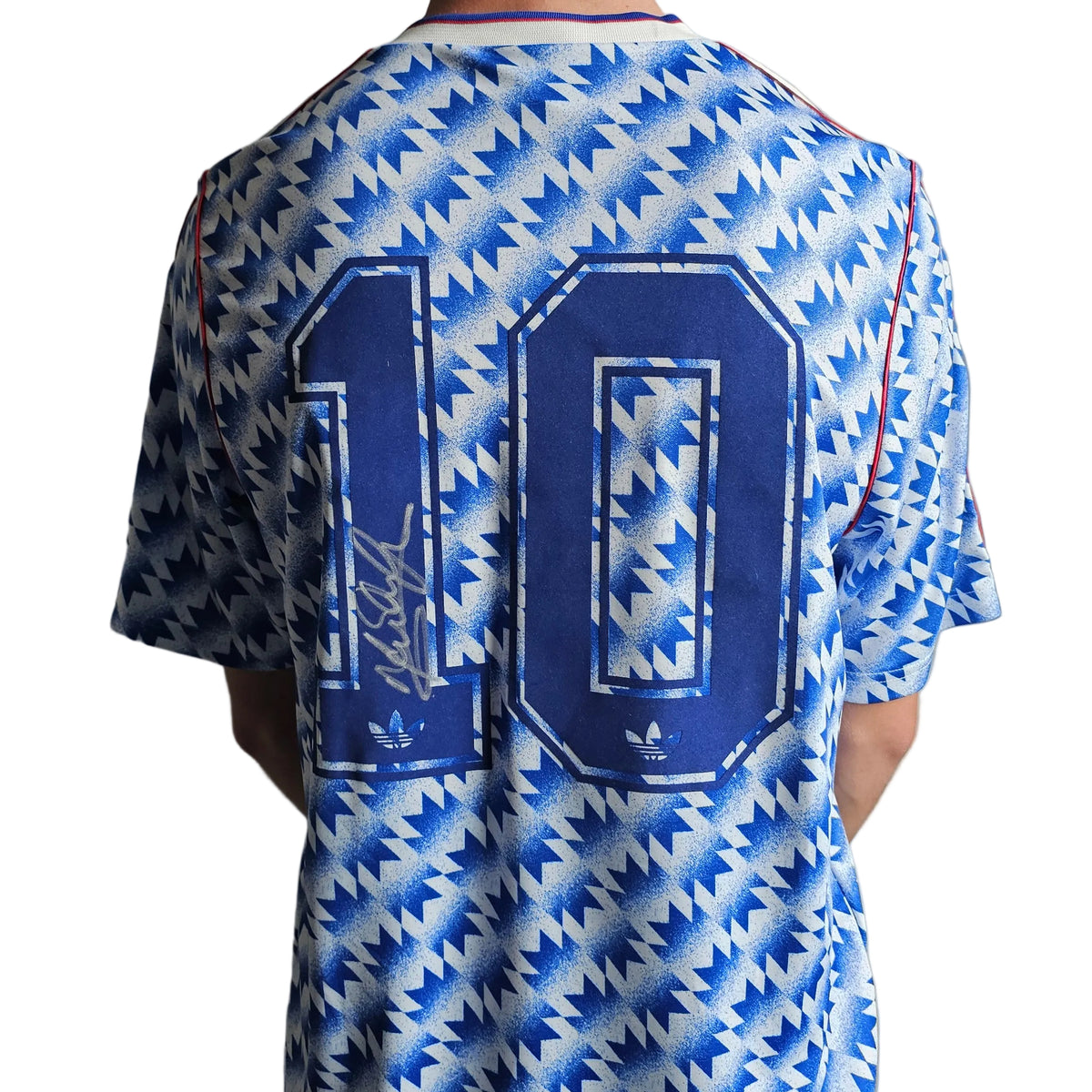 Back of the Mark Hughes signed Manchester United 1991-92 away design reissue, silver signature on the navy 1 of the 10
