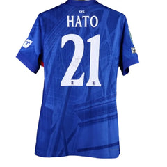 Back view showing HATO and No. 21 with a visible signature on the blue football shirt.