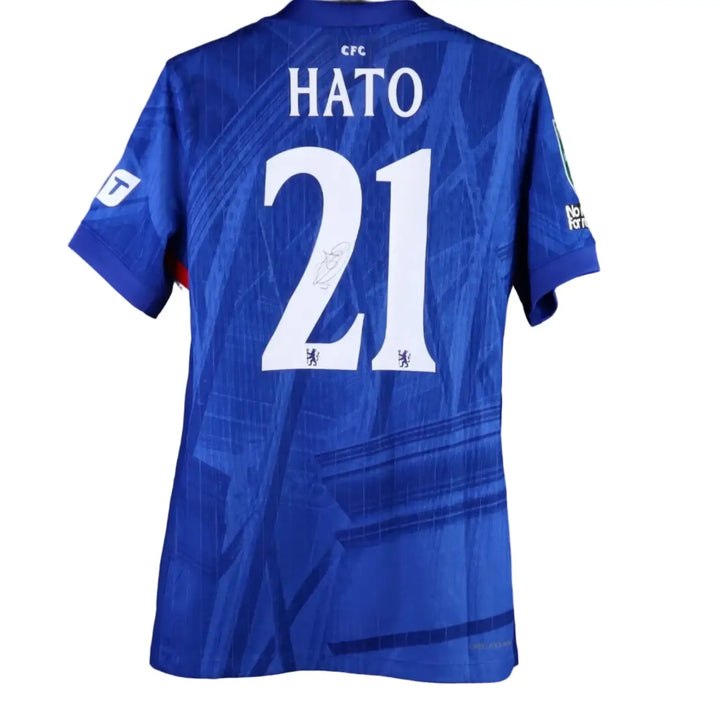 Back view showing HATO and No. 21 with a visible signature on the blue football shirt.