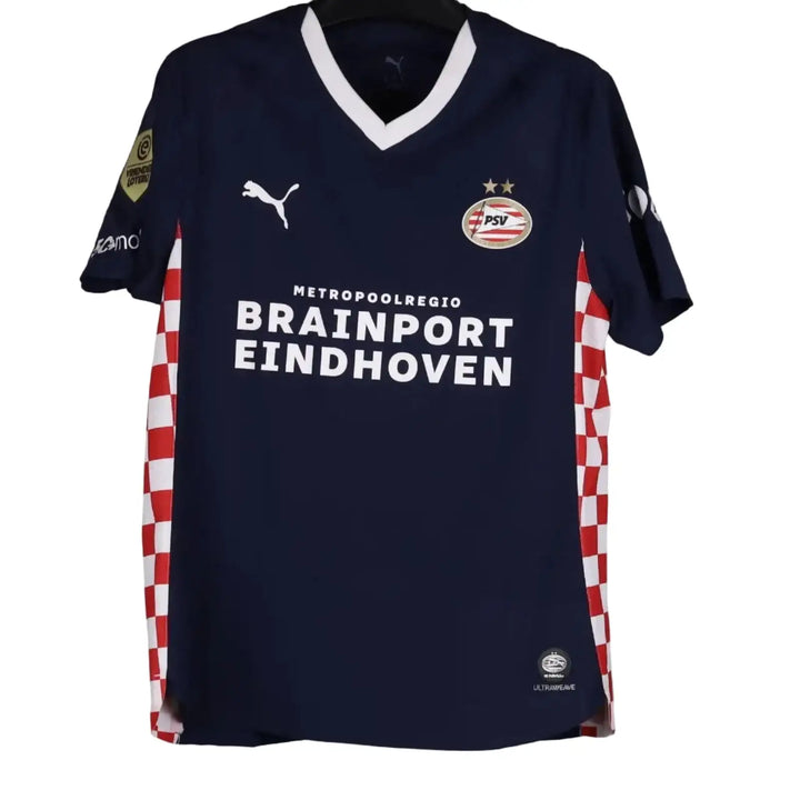 Navy sports shirt with visible branding on a gray background