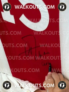Signature detail of Arie Haan on a vintage Ajax football shirt, featuring a red background with a white number 15.