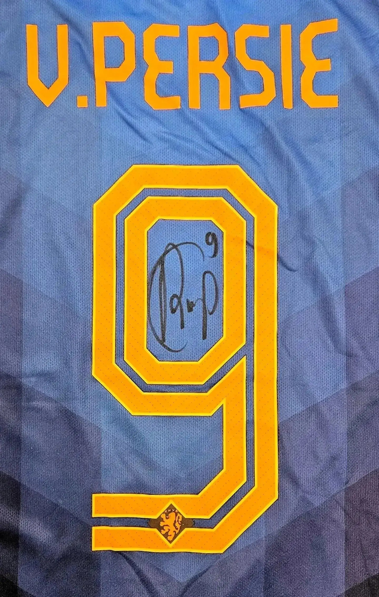Back view showing signature and No. 9 on a blue and orange soccer jersey.