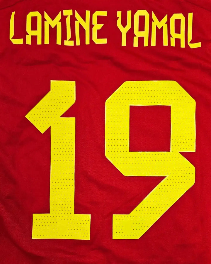 Back view showing Lamine Yamal and No. 19 in yellow on a red football shirt.
