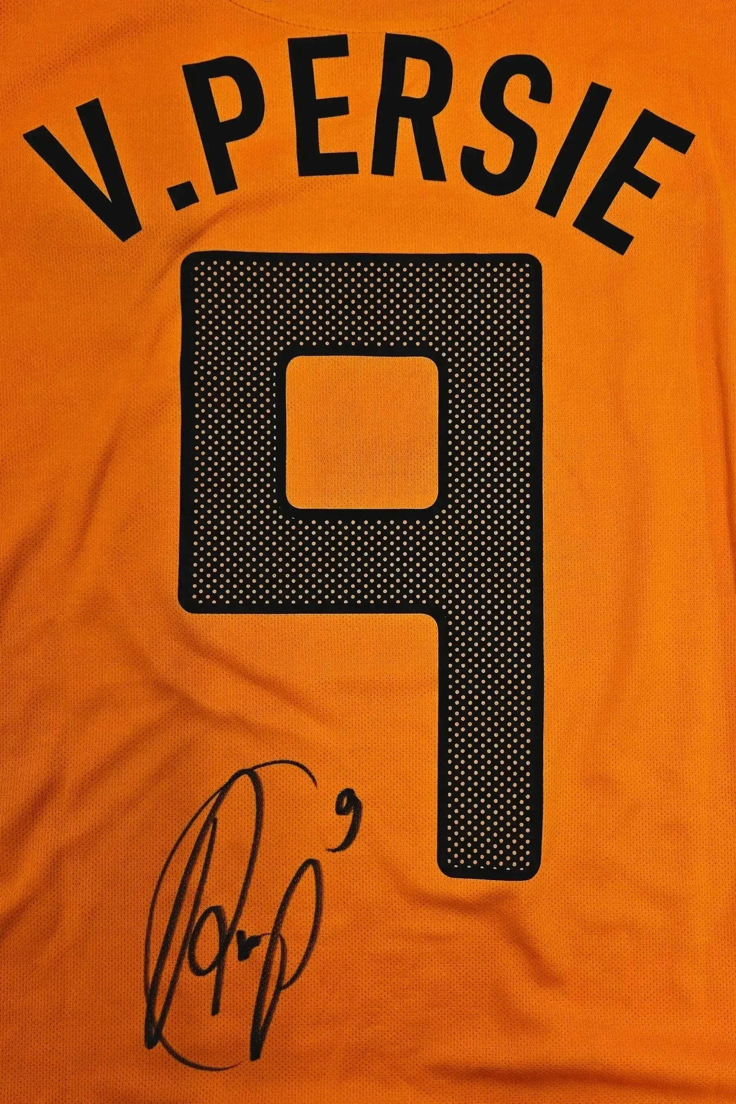 Back view showing V. Persie, No. 9, and signature on an orange football shirt.