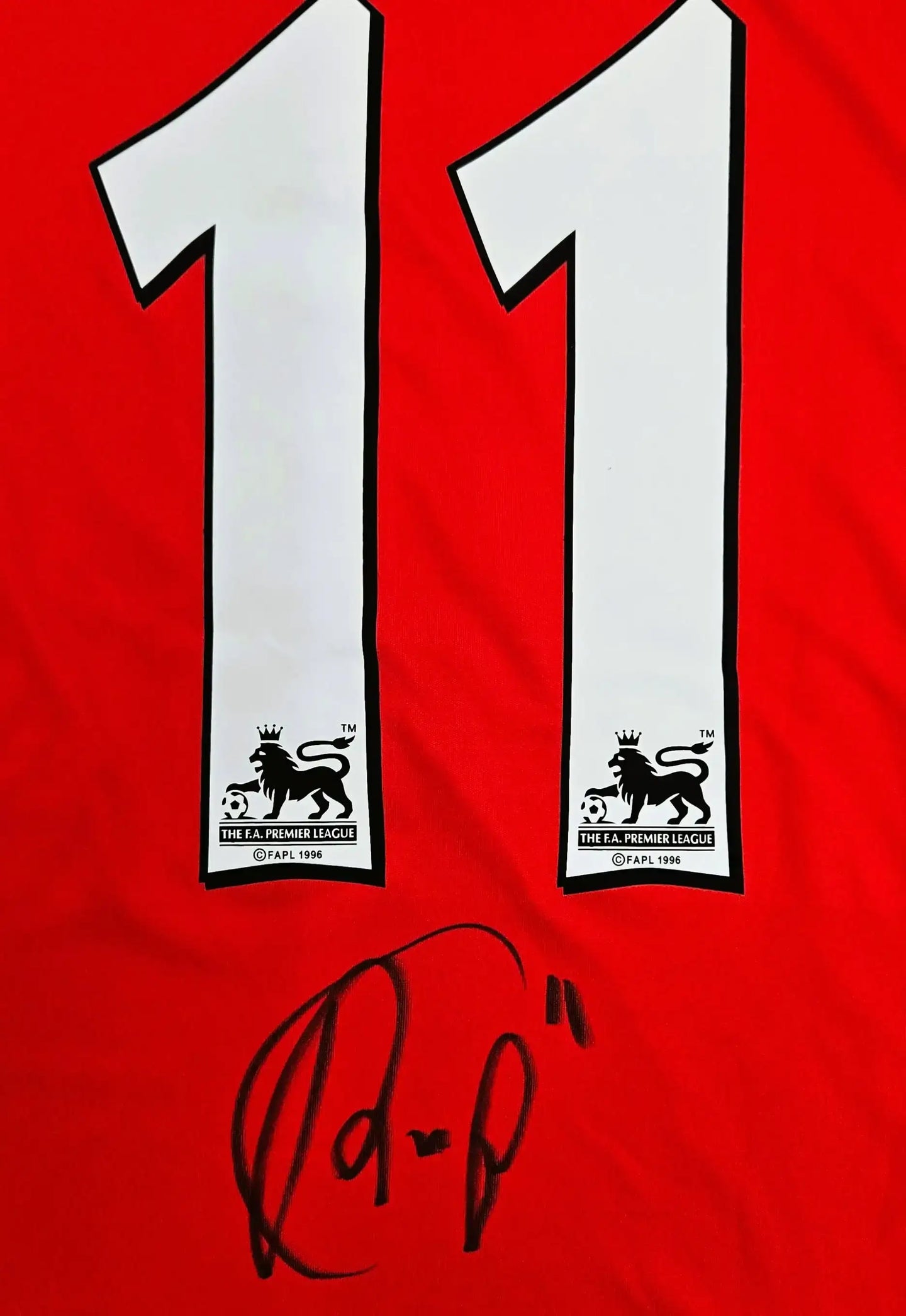 Detail view showing No. 11 and signature RvP on the red football shirt.