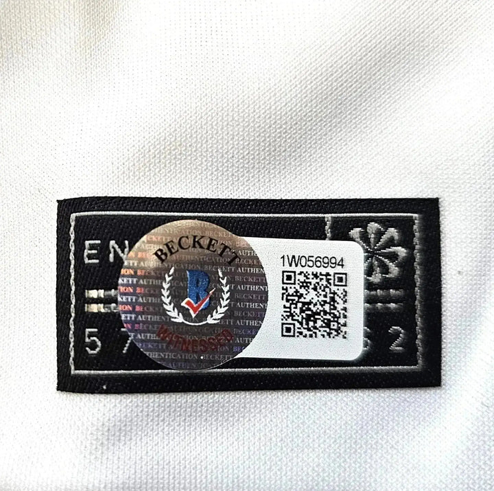 Beckett authenticity tag with serial number 1W056994 on a soccer jersey.