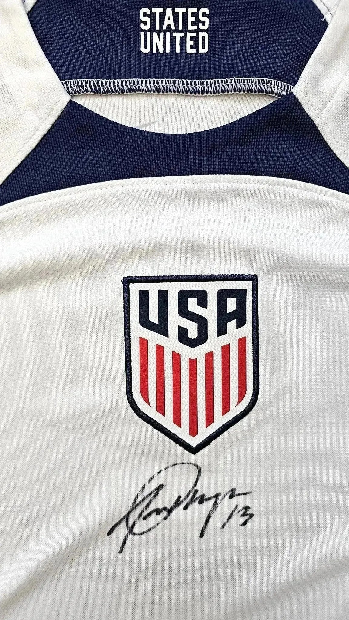 Crest detail showing USA badge and signature of Alex Morgan with No. 13.