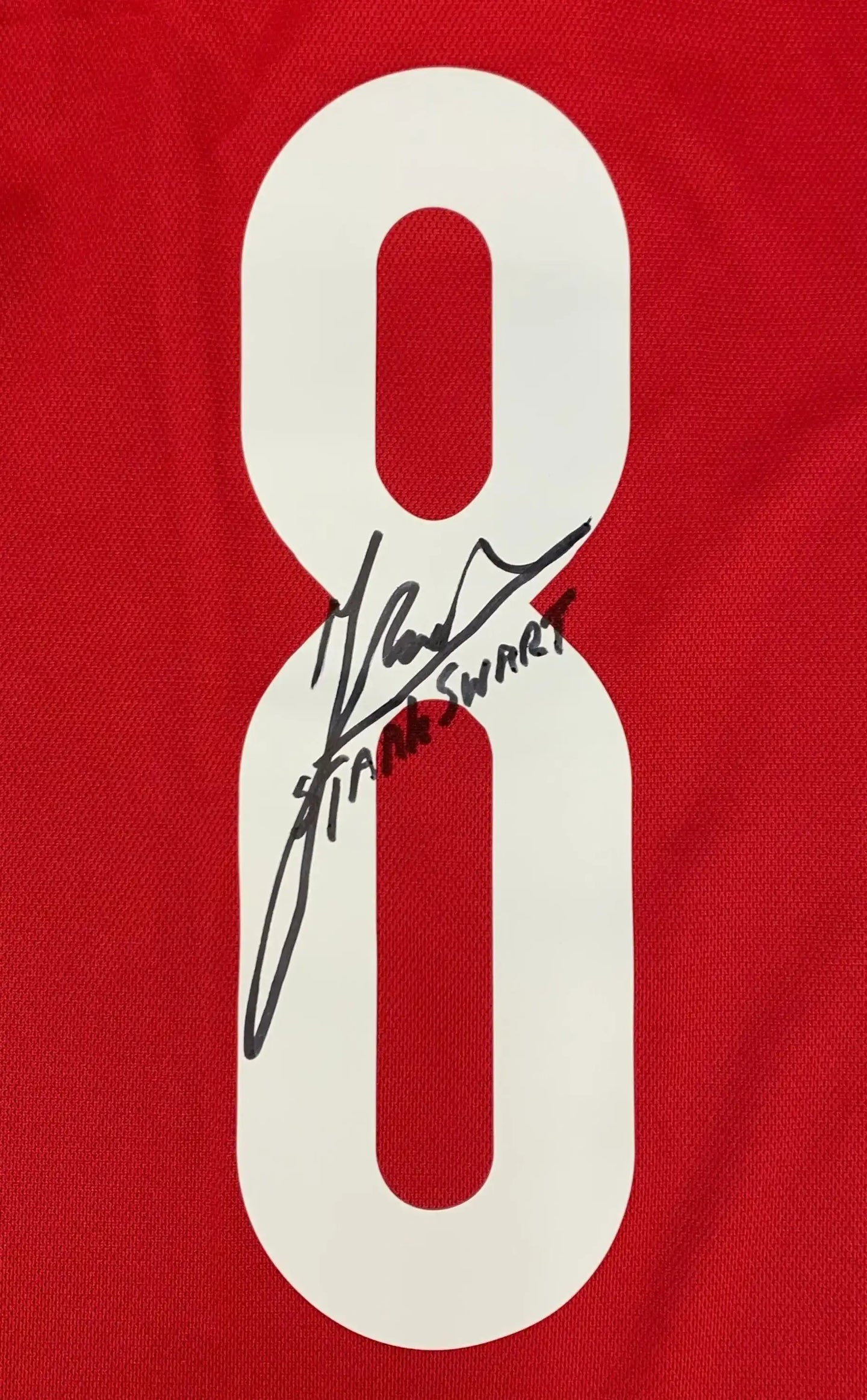 Detail view of red football shirt showing No. 8 and signature of Sjaak Swart.