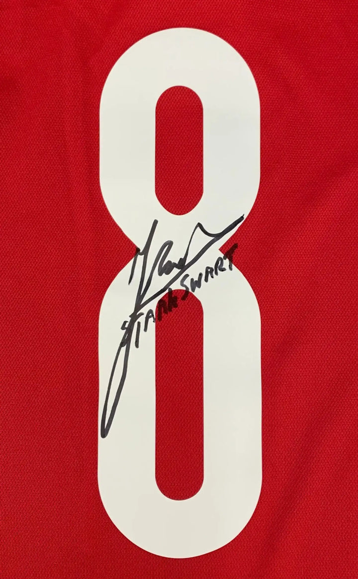 Detail view of red football shirt showing No. 8 and signature of Sjaak Swart.