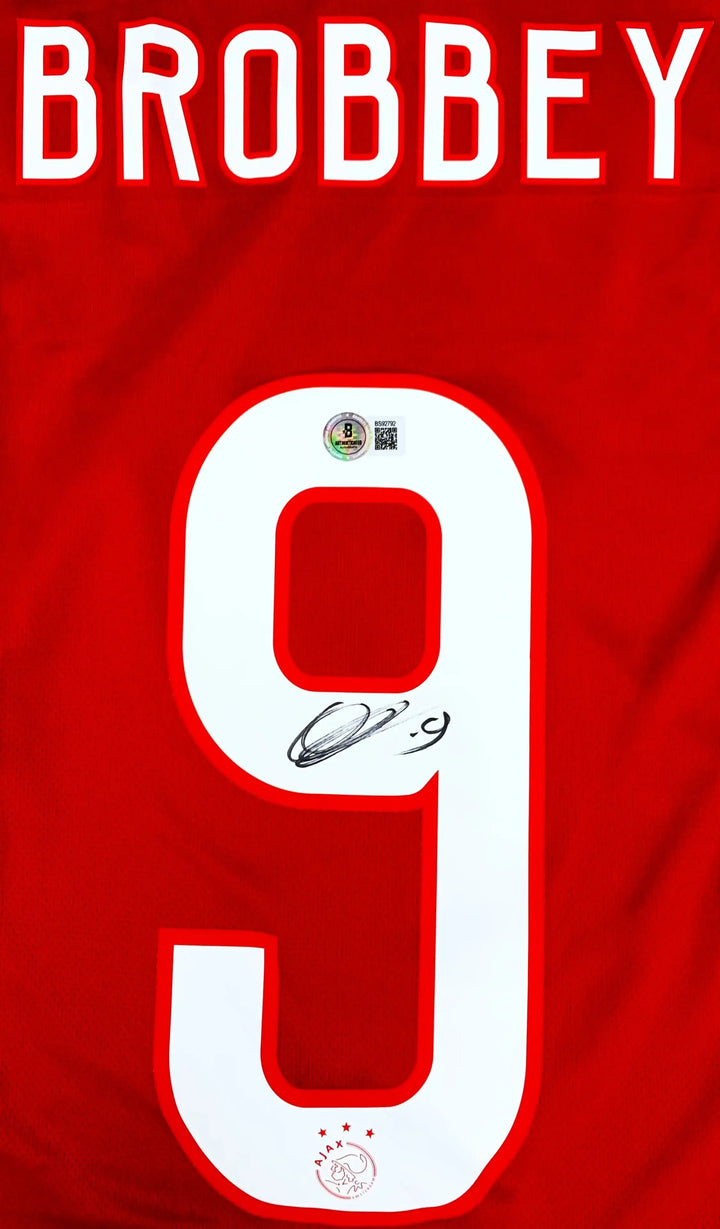 Back view showing Brobbey, No. 9, and signature detail on red shirt.