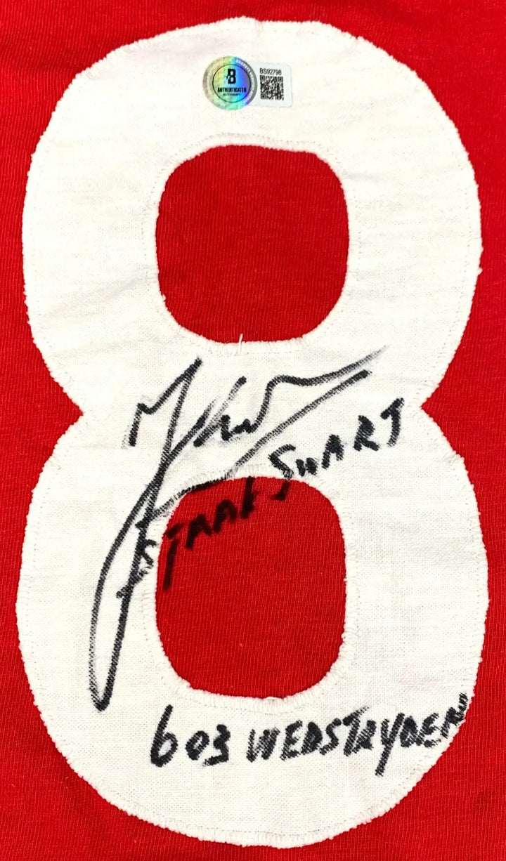 Signature of Sjaak Swart on white No. 8 detail, with 603 wedstrijden printed below, on red background.