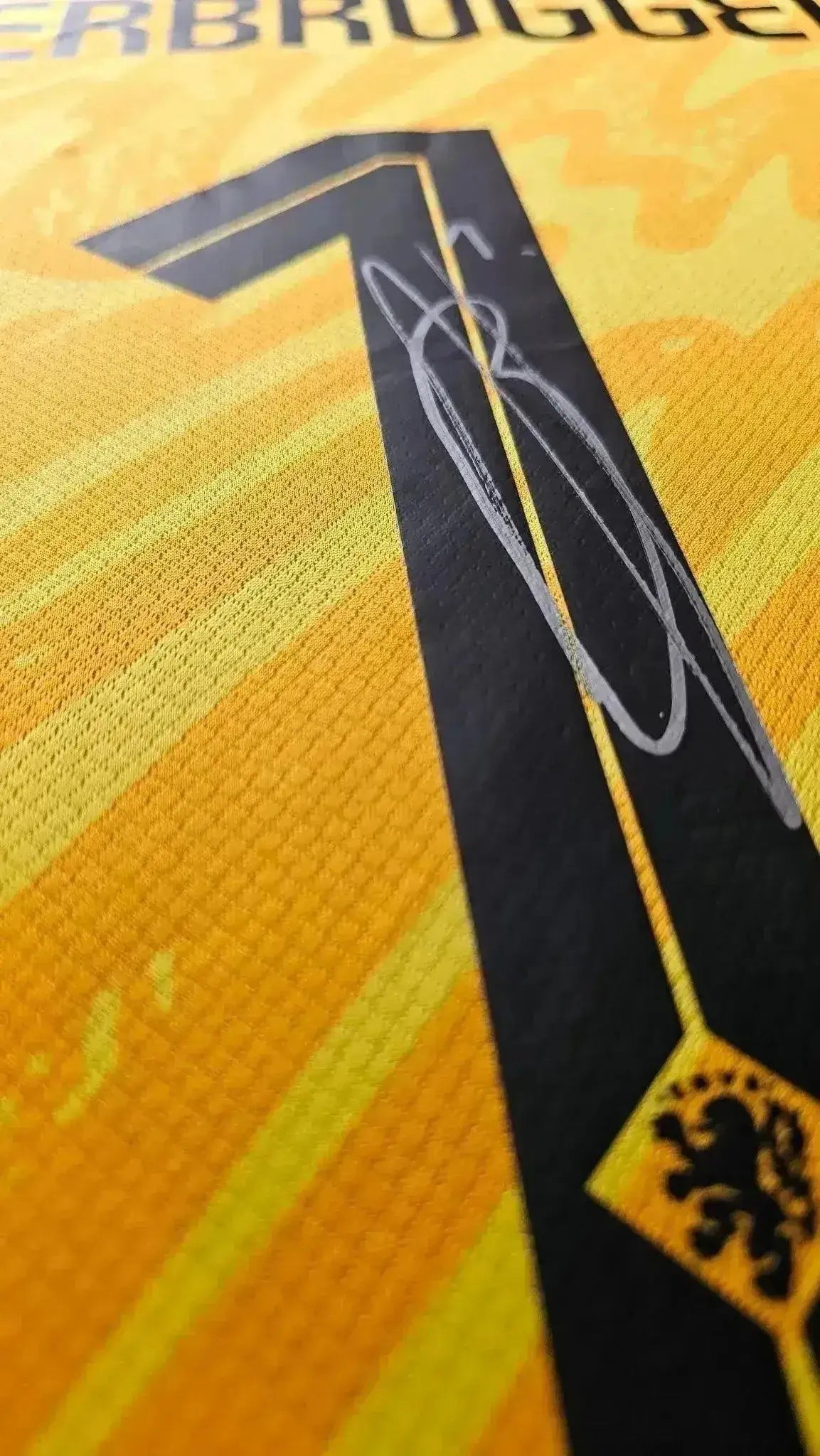 Close-up of No. 1 with Bart Verbruggen's signature on yellow fabric.