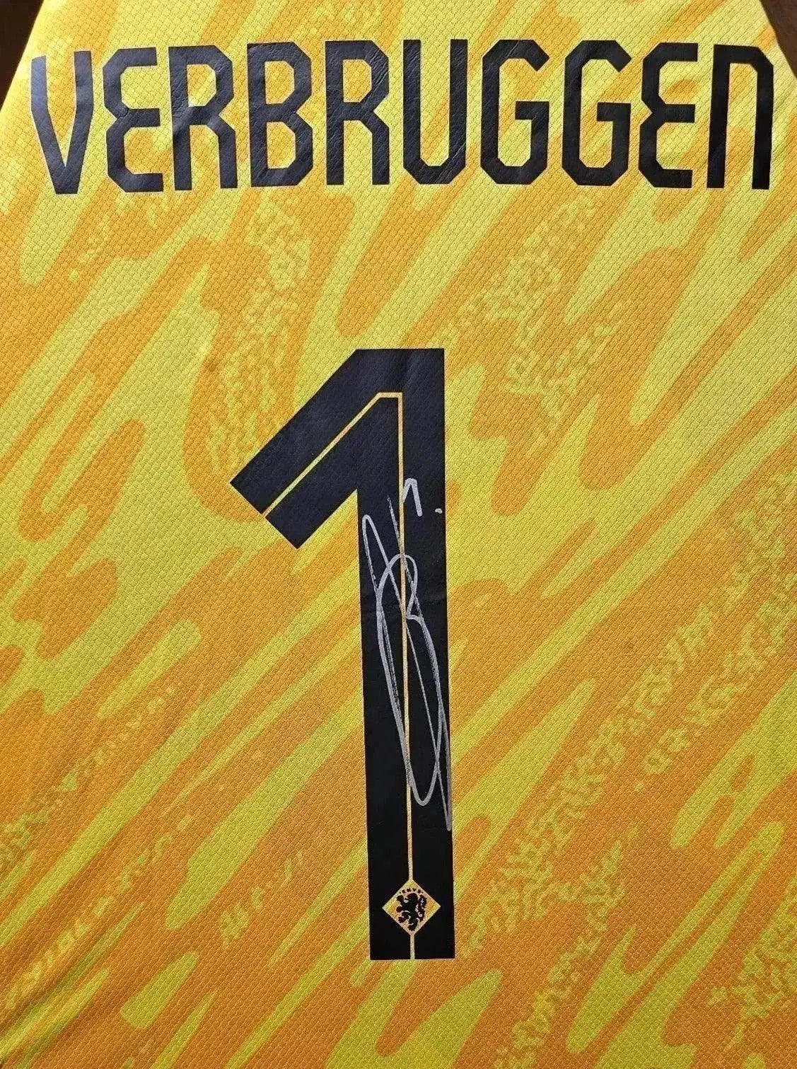 Back view showing No. 1, name Verbruggen, and a visible signature.