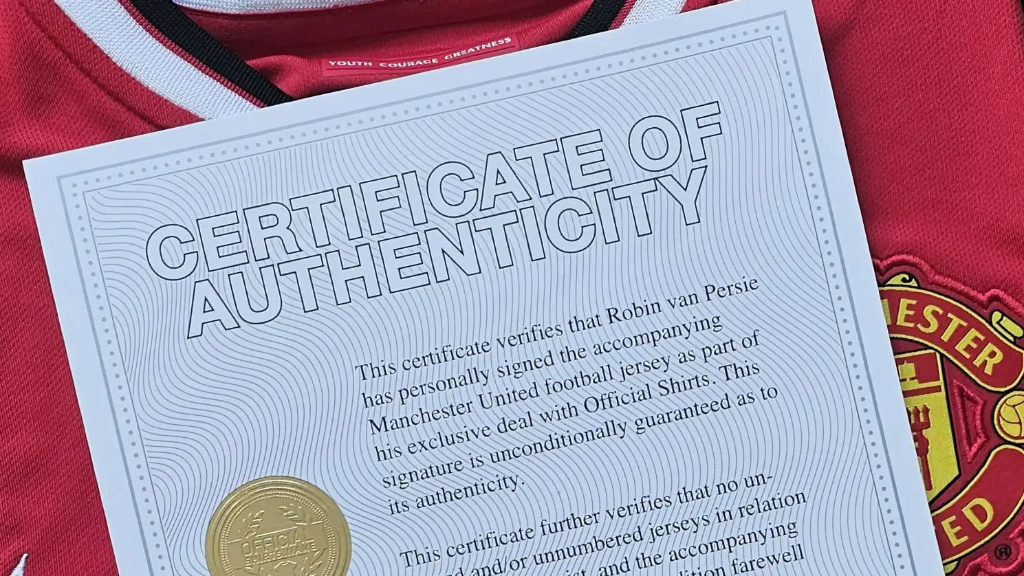 Manchester United football shirt with a certificate of authenticity on a red background.