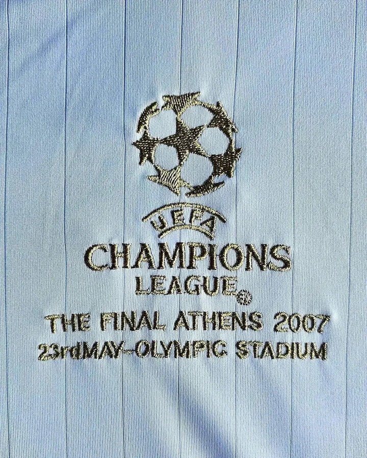 Detail of UEFA Champions League logo and final information embroidered on shirt.