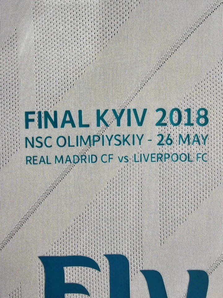 Detail featuring text: FINAL KYIV 2018, NSC OLYMPIYSKIY - 26 MAY, REAL MADRID CF vs LIVERPOOL FC.