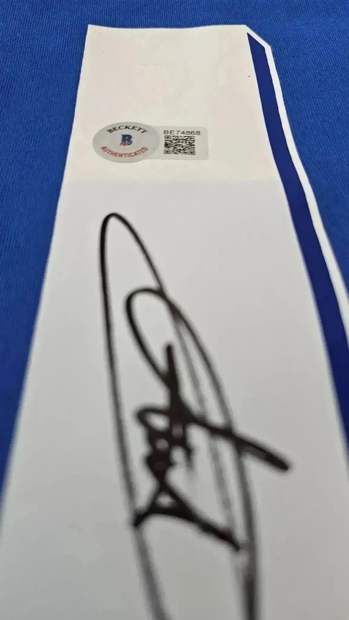 Detail showing Didier Drogba's signature with Beckett authentication sticker.