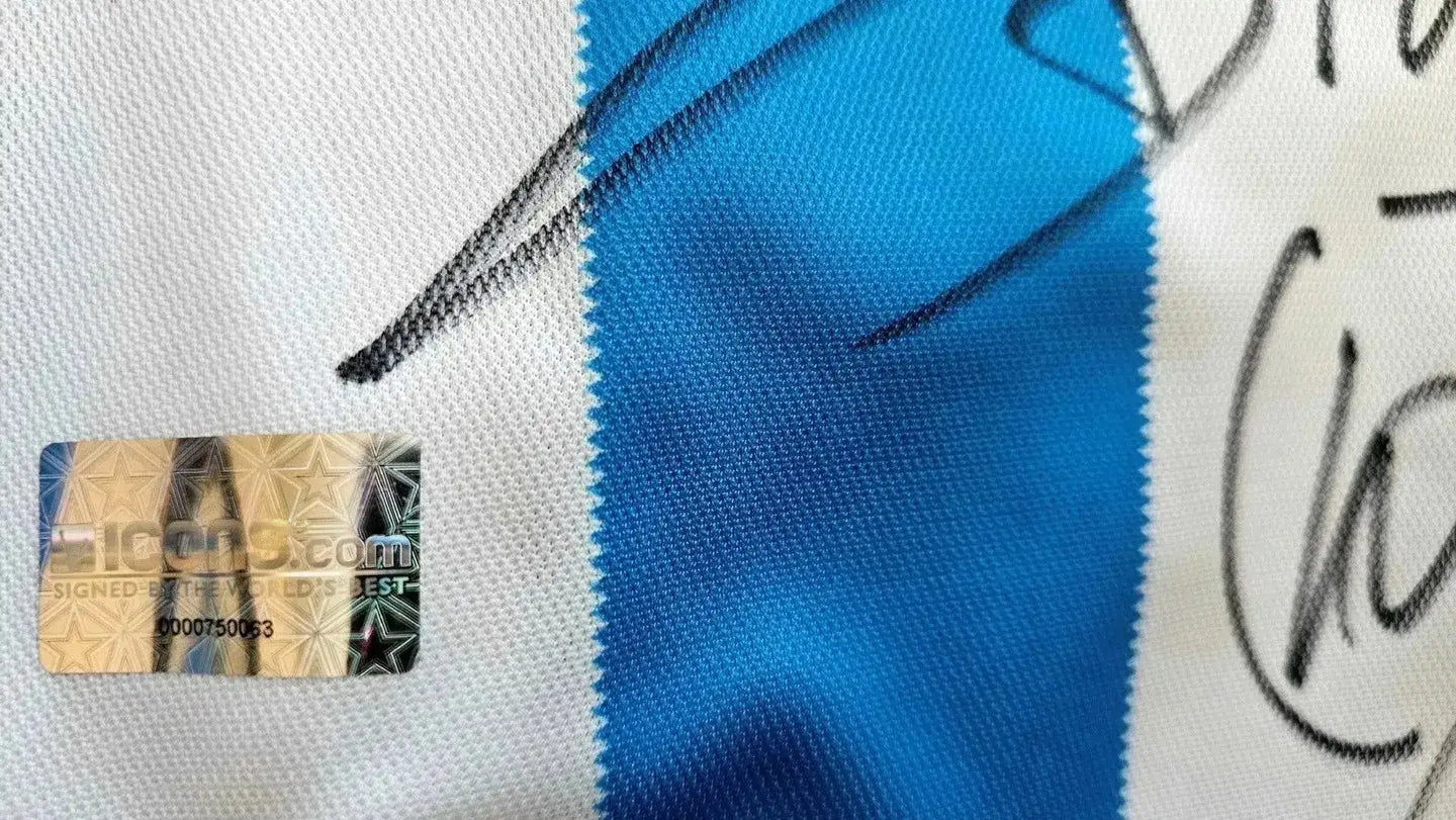 Close-up of the label with certification details and Diego Maradona's signature on the blue and white jersey.