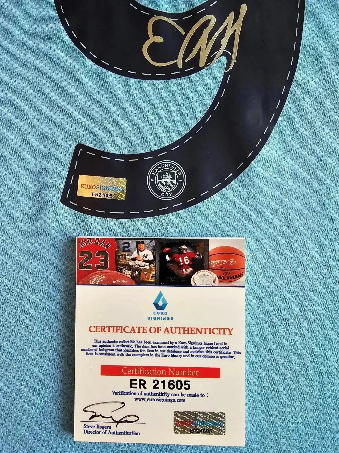 Detail showing signature of Erling Haaland on the No. 9 Manchester City soccer jersey with certificate of authenticity.