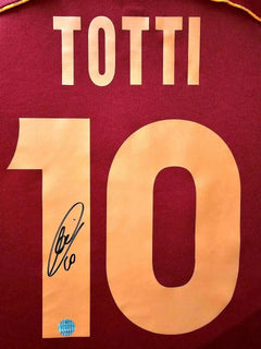 Back view showing Totti, No. 10, and a visible signature on a red soccer jersey.