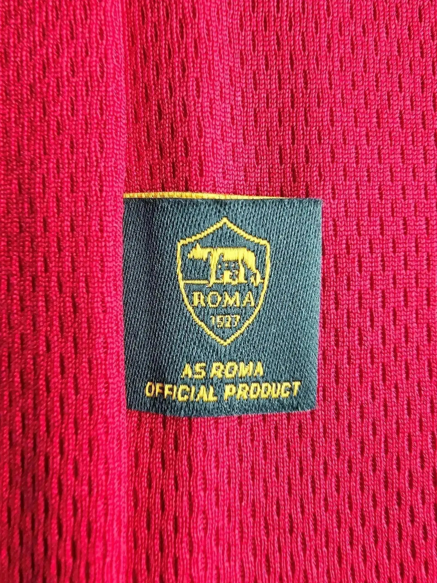 AS ROMA 1927 label in gold on a red texture, indicating official product.
