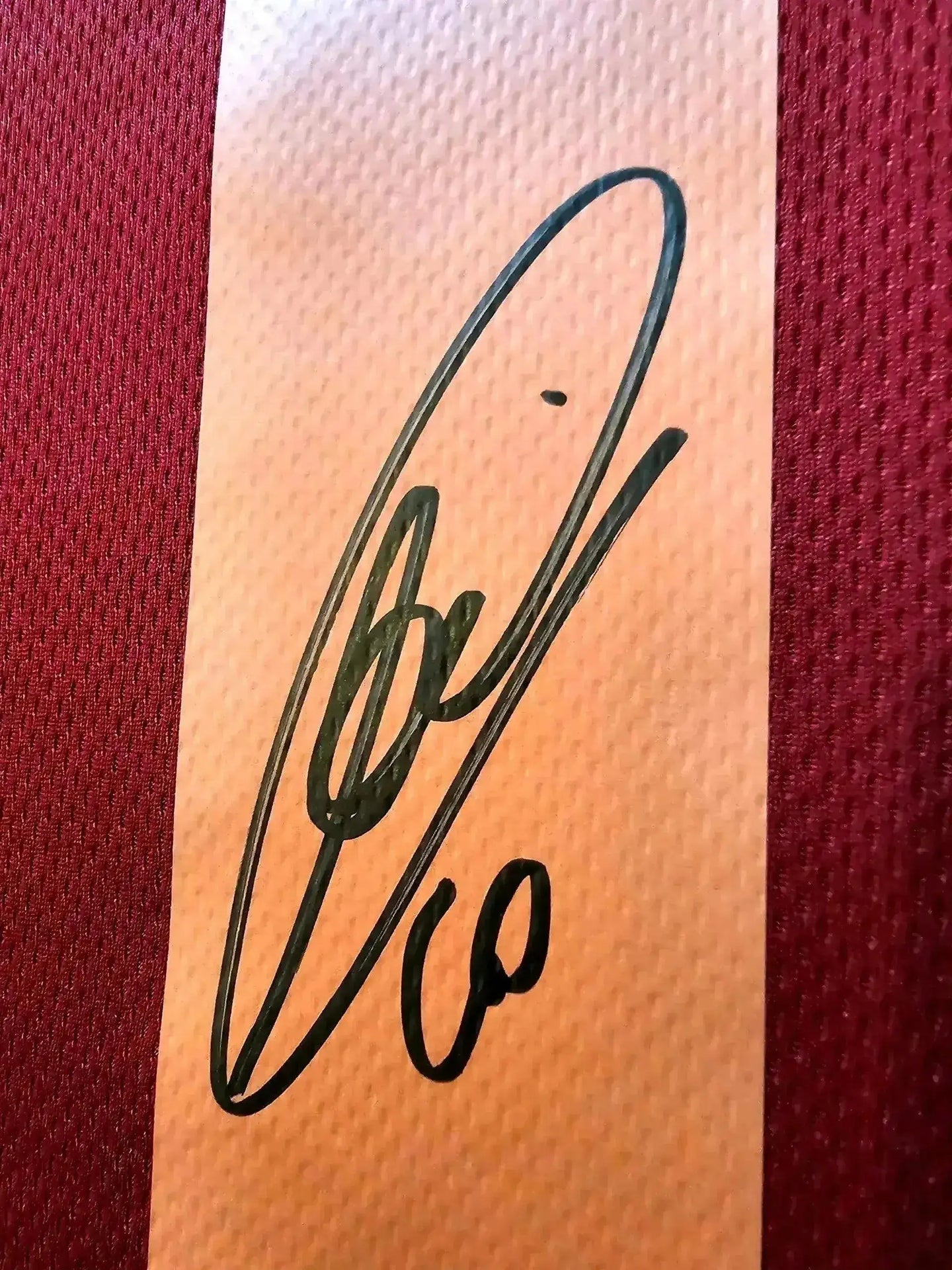 Close-up of Francesco Totti's signature on the AS Roma 1998-1999 home soccer jersey.