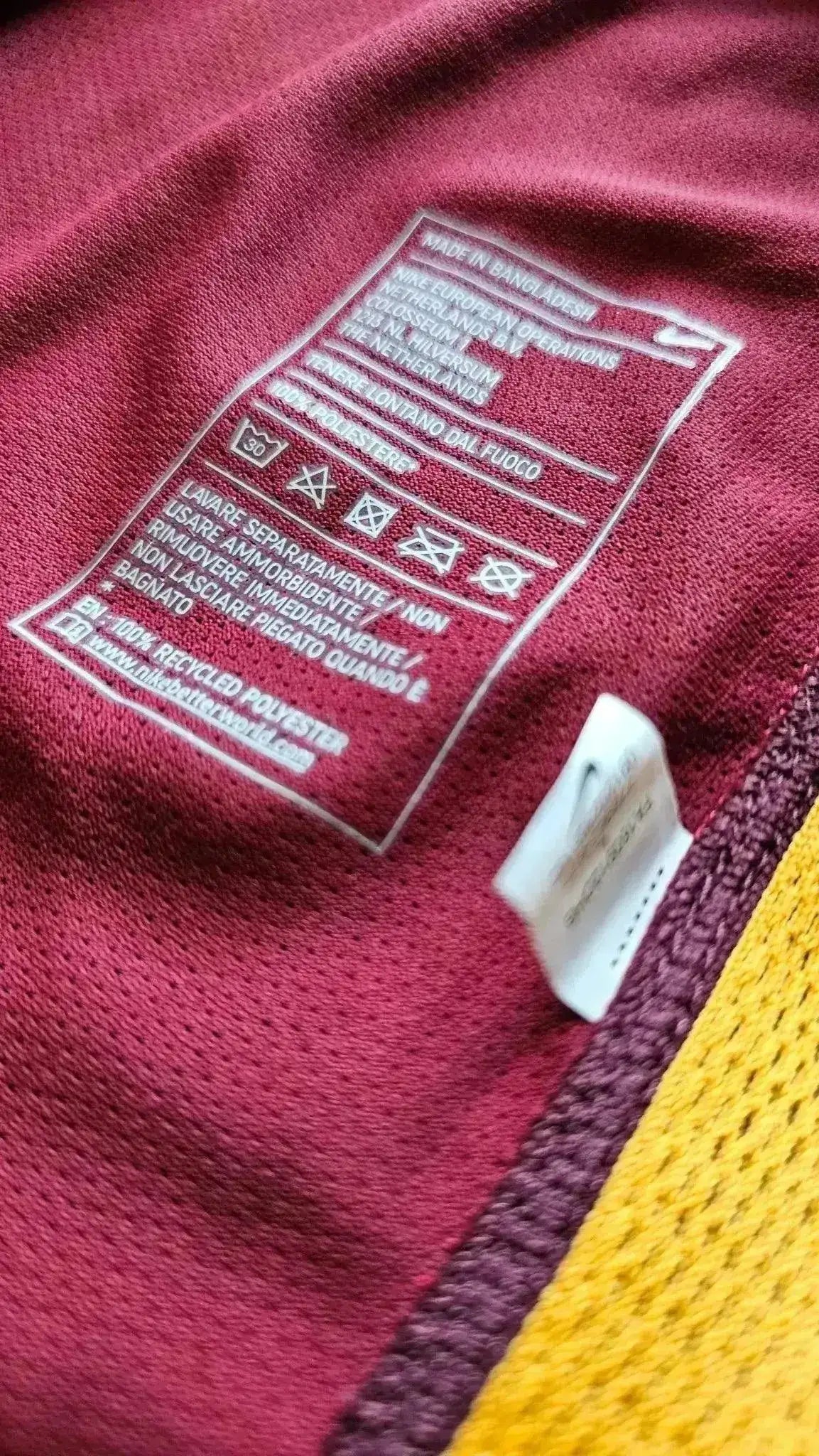 Care label showing care instructions and fabric details for Francesco Totti 10 Roma football shirt.