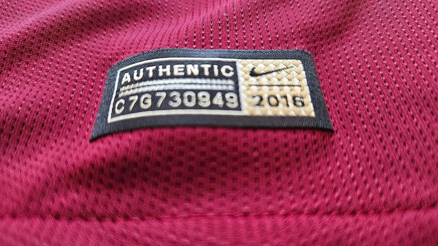 Close-up of the label showing AUTHENTIC, C7G730849, and 2016 on a red fabric.
