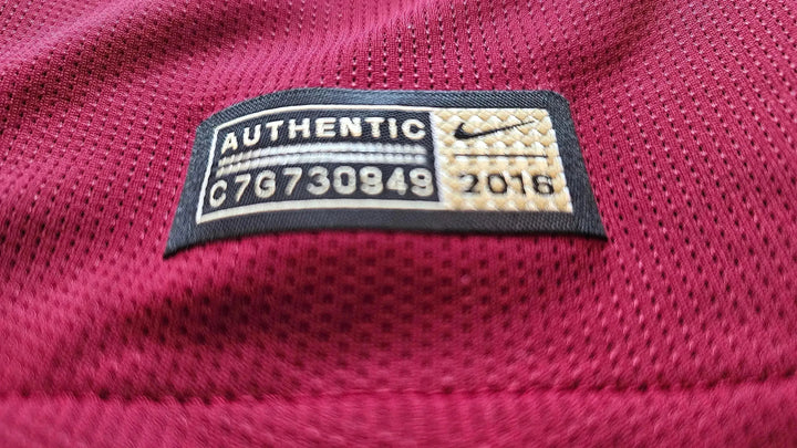 Close-up of the label showing AUTHENTIC, C7G730849, and 2016 on a red fabric.