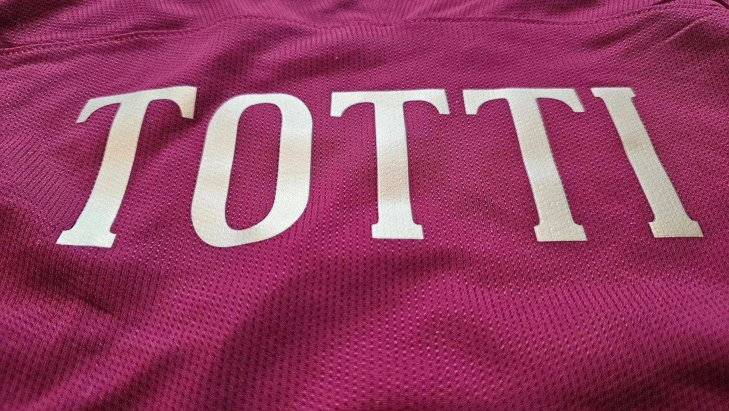 Back view showing the name 'TOTTI' in white lettering on a red background.
