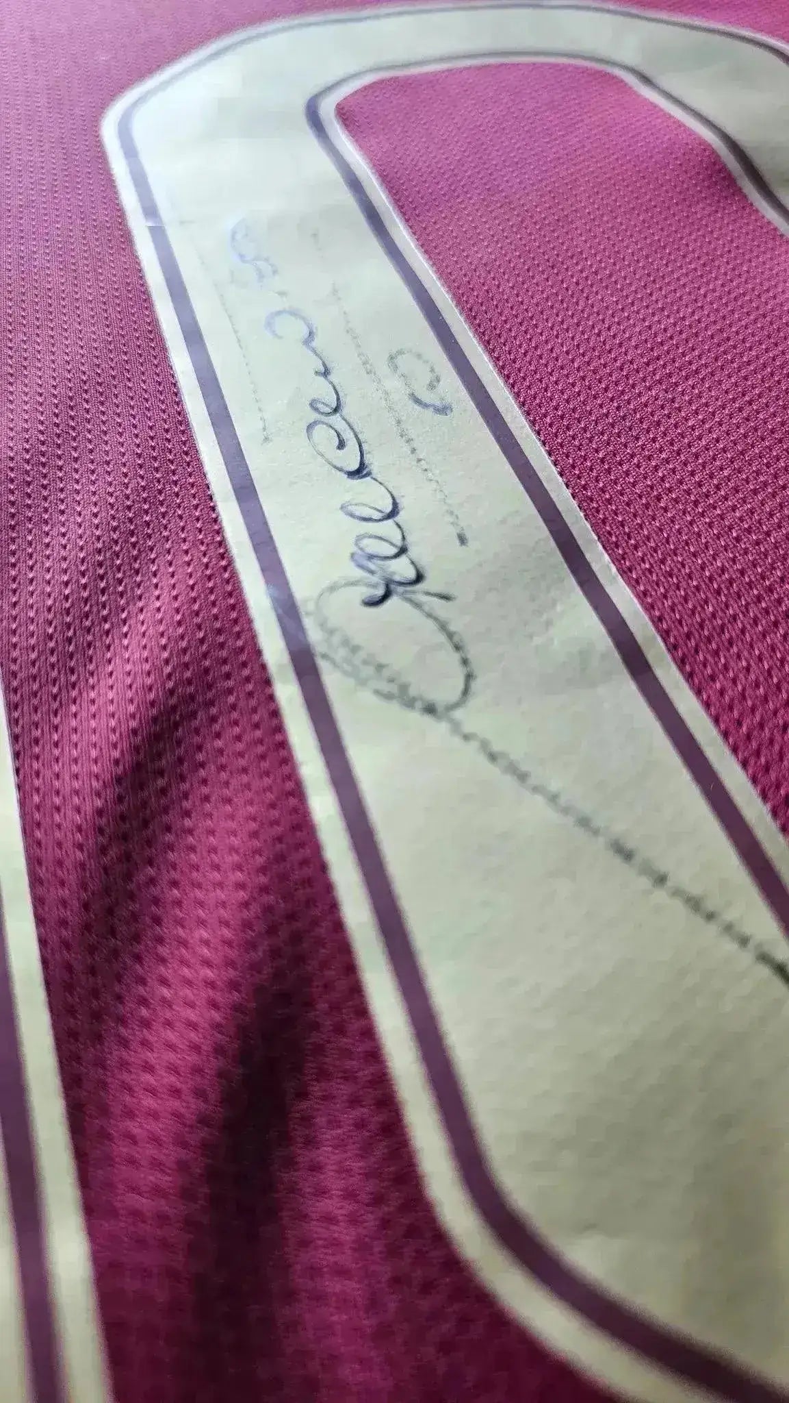 Close-up of Francesco Totti's signature on the No. 10 detail of the Roma shirt.