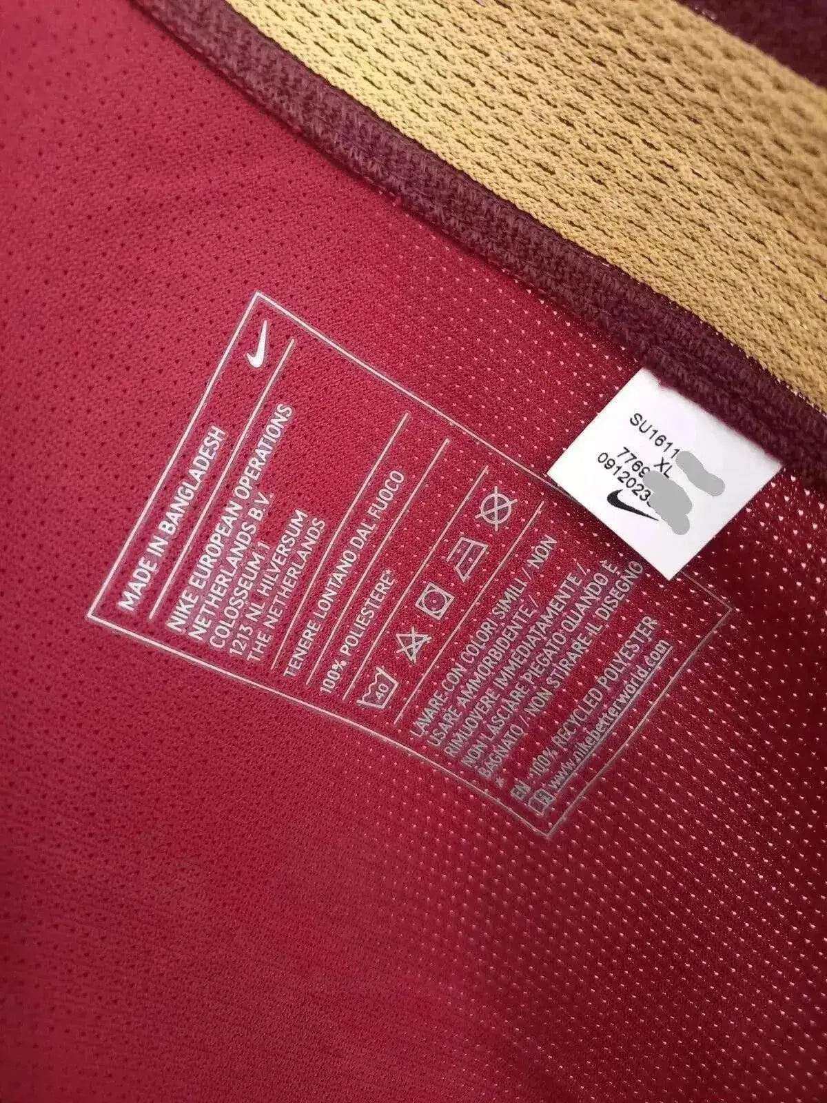 Care label featuring Nike branding, size XL, and material details. Color: Red with gold accents.