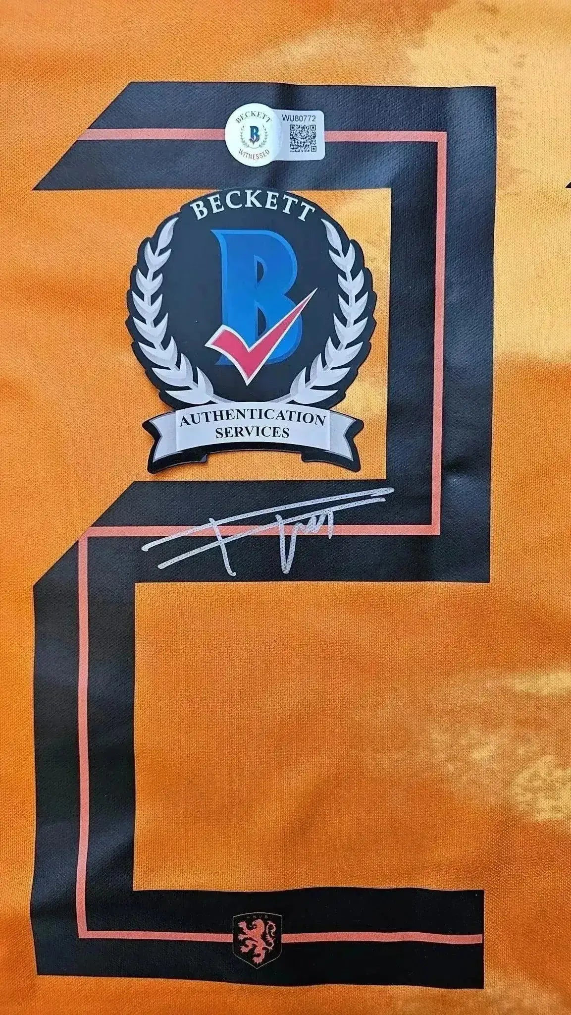 Detail view showing signature and Beckett authentication stamp on number 21.