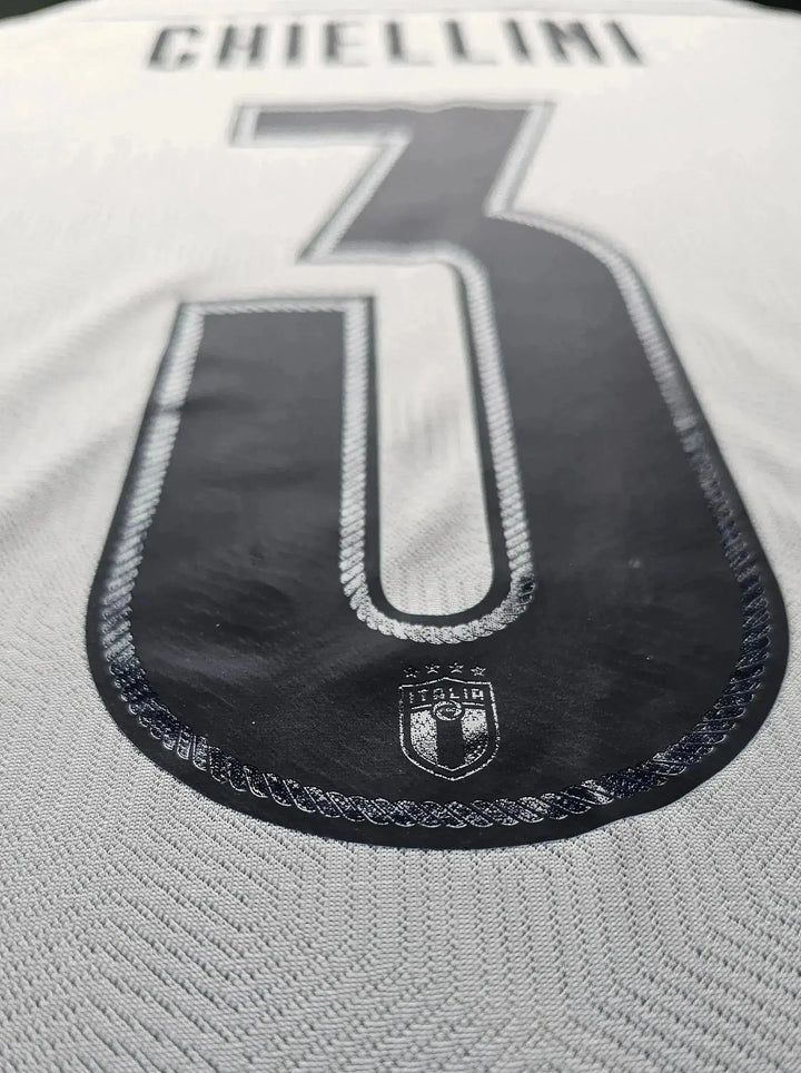 Chiellini No. 3 detail showing crest with three stars and textured fabric.