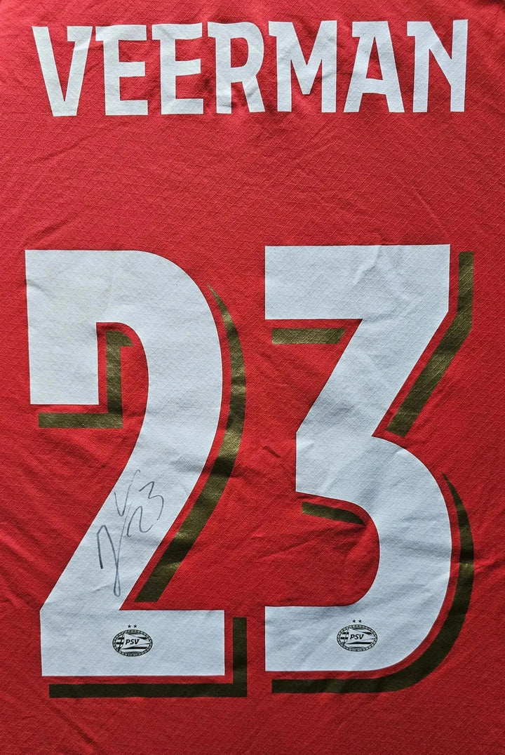 Back view showcasing No. 23 and signature of Veerman on a red PSV football shirt.