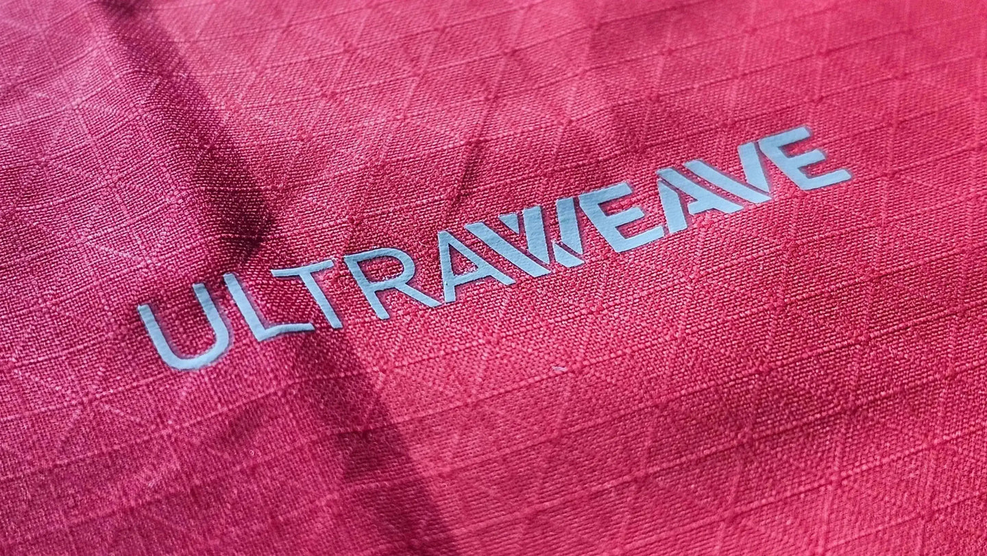 Close-up of the Ultraweave text on a red soccer jersey fabric, highlighting its texture.