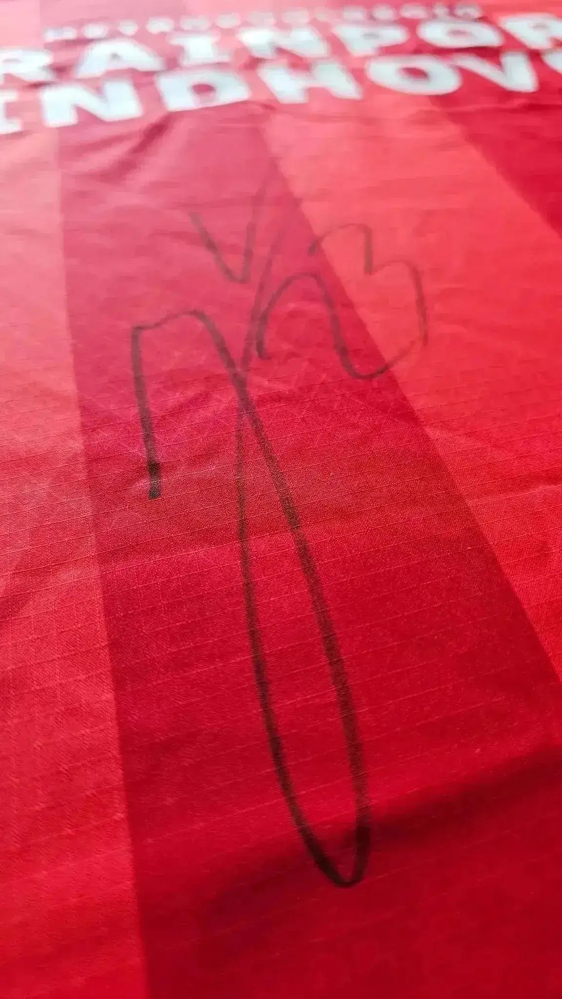 Signature detail on a red PSV shirt featuring the name and number.