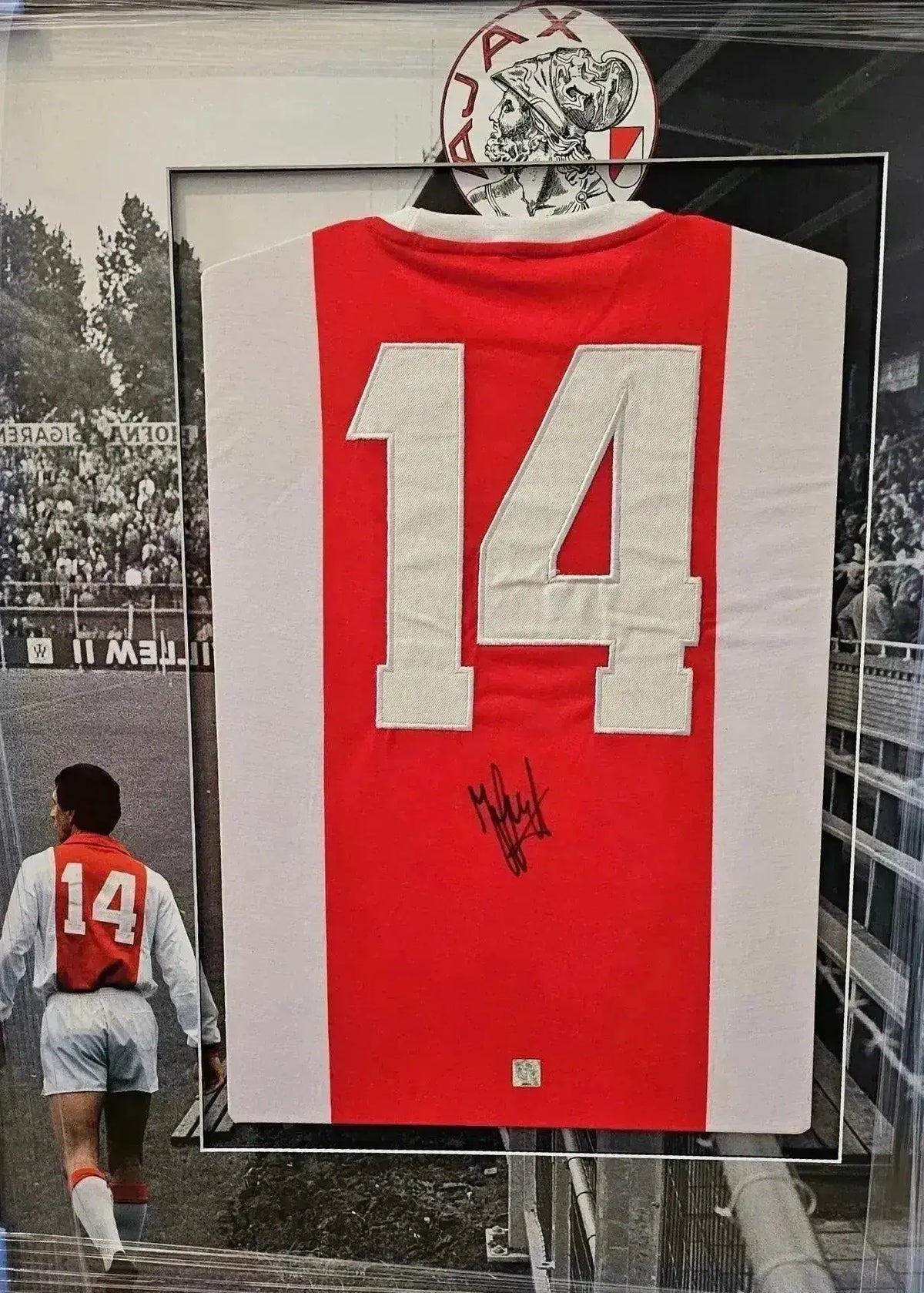 Back view showing No. 14 and signature of Johan Cruyff on Ajax home soccer jersey.