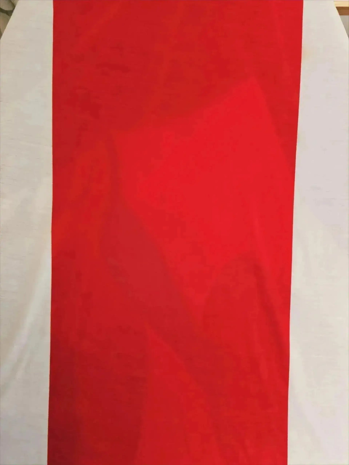 Front view of Johan Cruyff's signed Ajax soccer jersey with red and white colors.