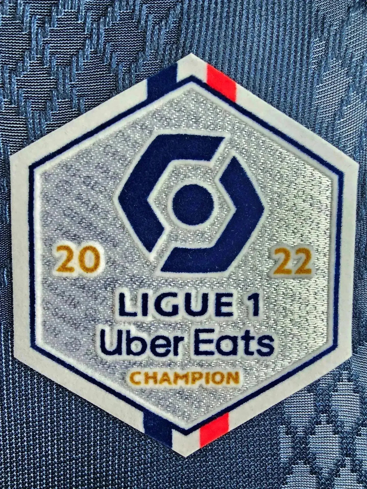 Ligue 1 Uber Eats Champion badge with 2022, featuring blue, white, and red detailing.