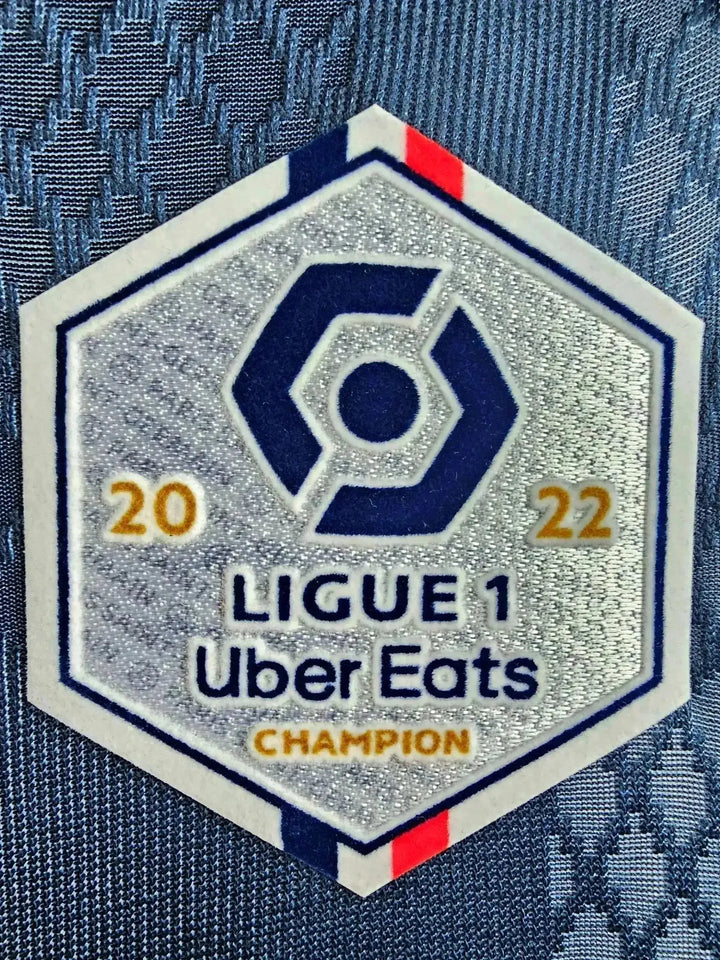 Ligue 1 Uber Eats Champion badge with 2022, featuring blue, white, and red detailing.