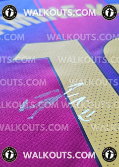 Close-up of signed shirt showing Lamine Yamal's number 10 in yellow and purple details.