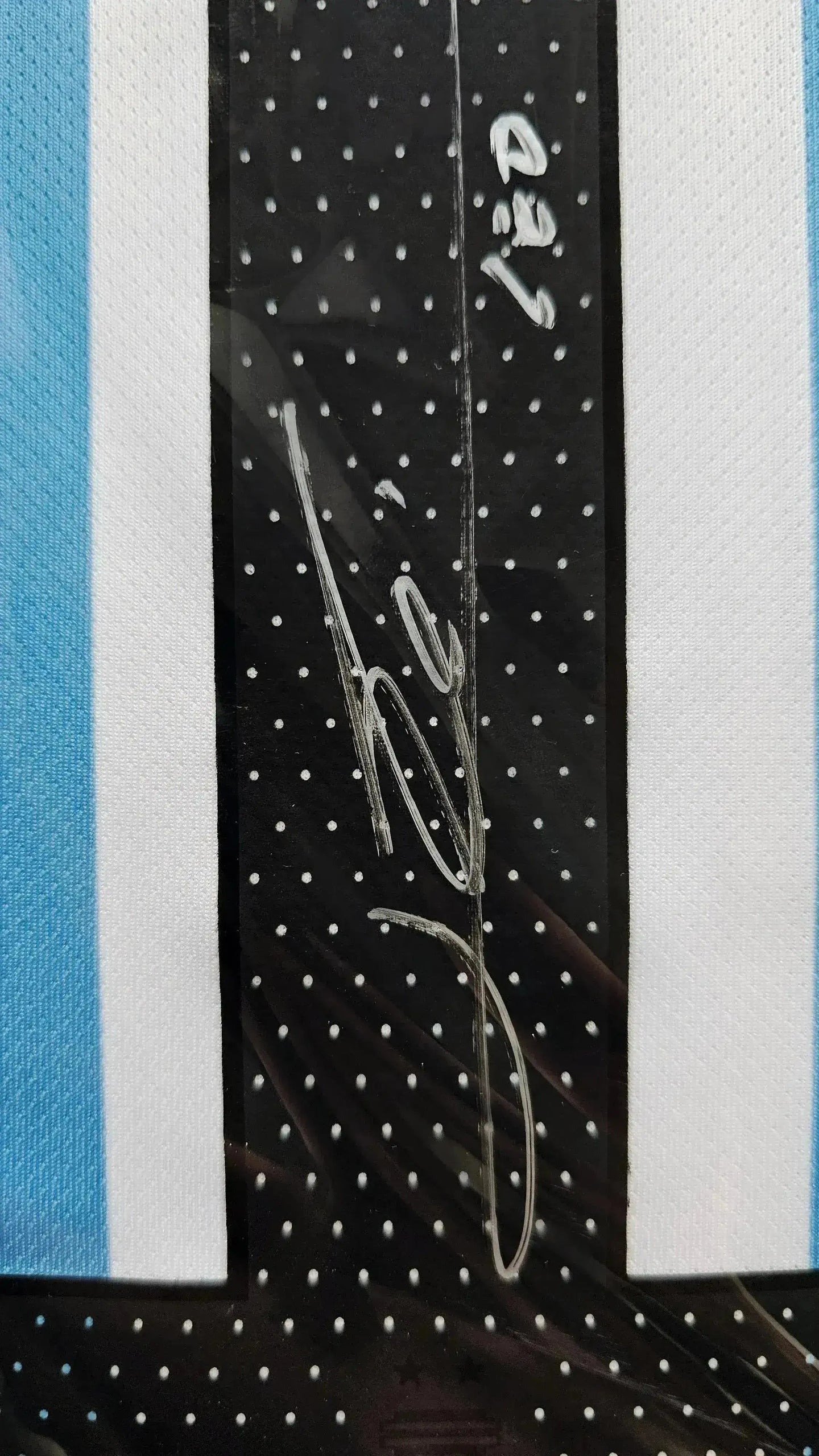 Close-up of signature detail on the Lionel Messi 10 Argentina soccer jersey.