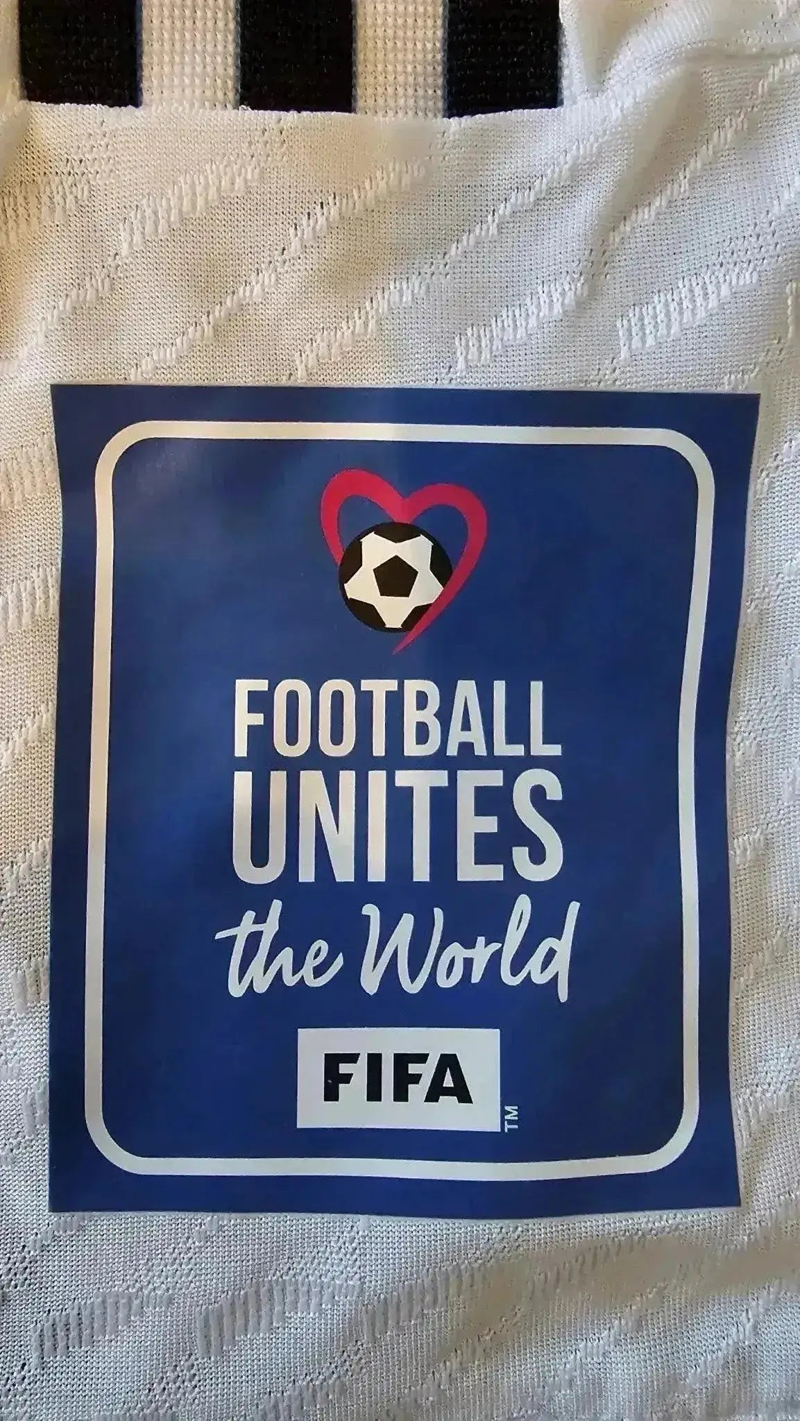 Detail showing FIFA tag with text: FOOTBALL UNITES the World.