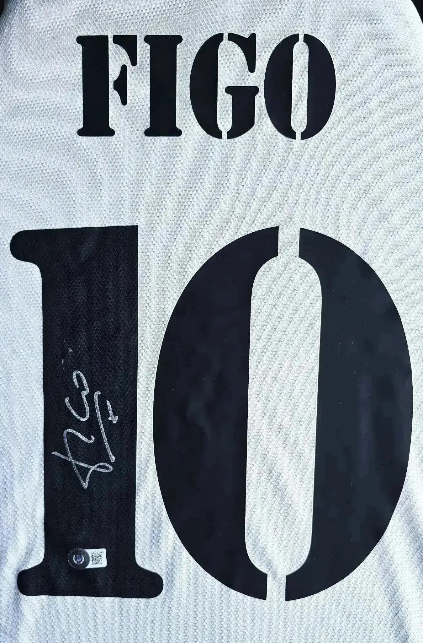 Back view showing No. 10 and signature of Figo on a Real Madrid soccer jersey.