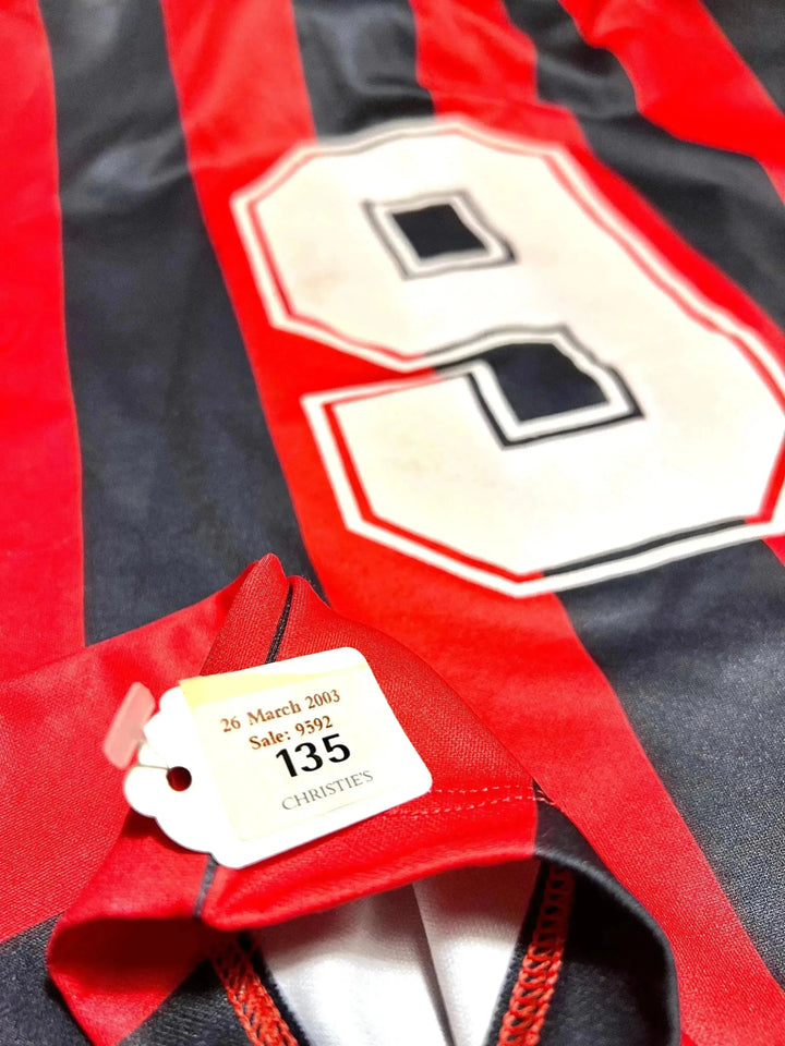 Close-up of No. 9 on red and black striped football shirt with Christie&