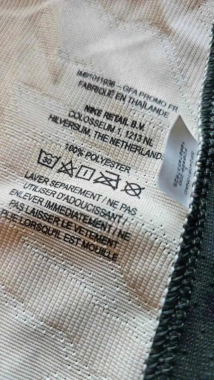 Care label on Marquinhos 5 Paris Saint-Germain 2023-2024 soccer jersey, featuring washing instructions and fabric details.
