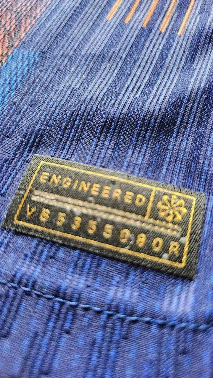 Close-up of the textile tag reading &