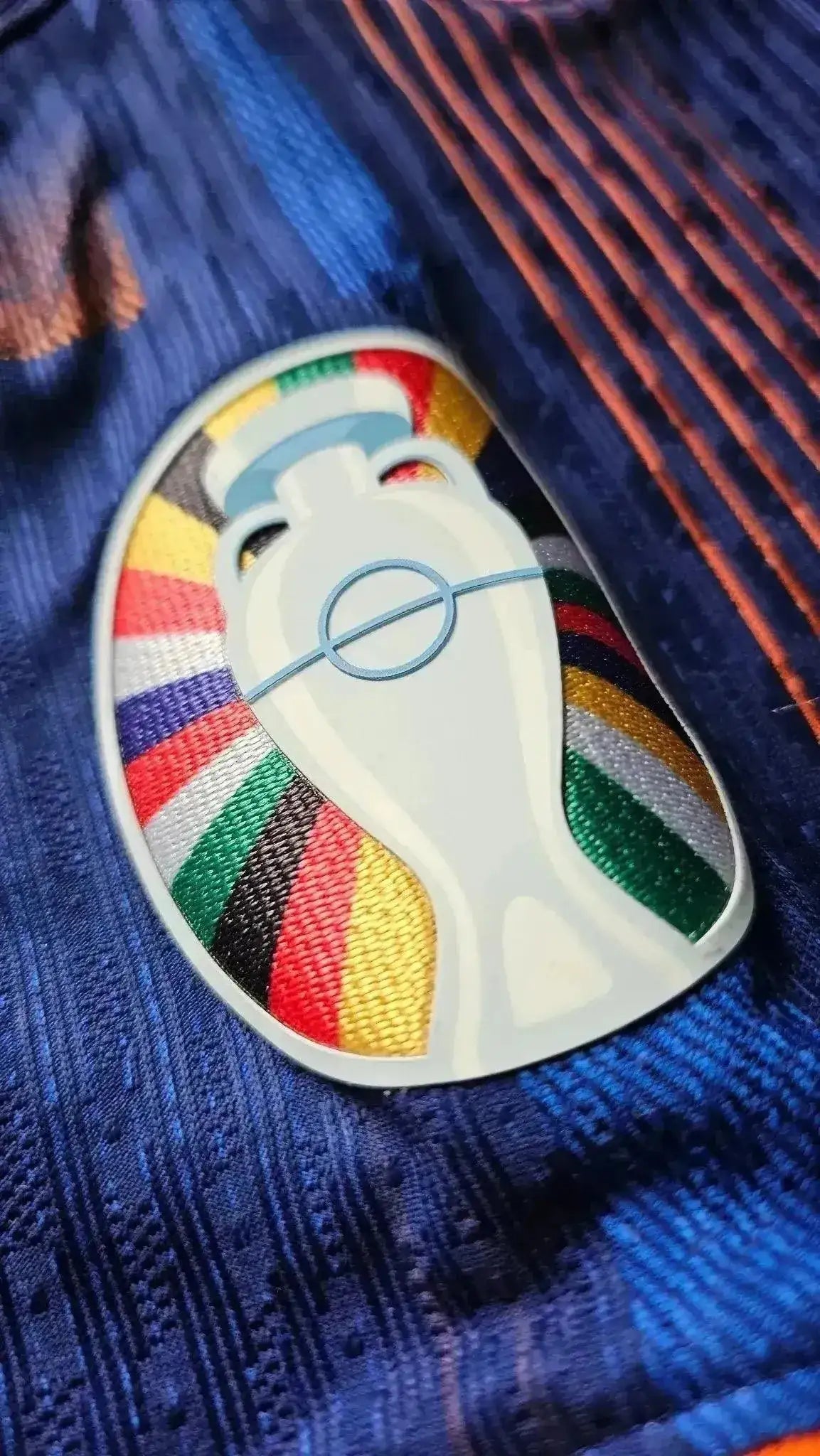 Close-up of the colorful Euro 2024 trophy crest on Memphis Depay's signed football shirt.