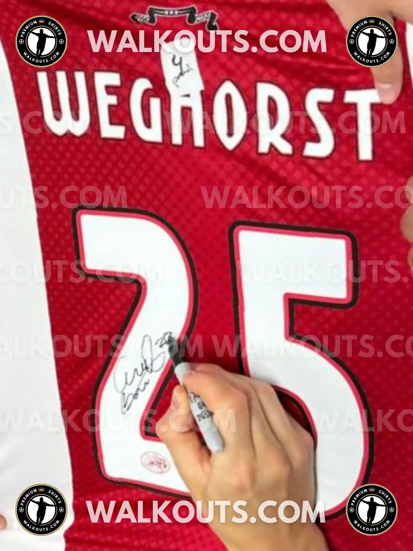 Wout Weghorst signing No. 25 on a red soccer jersey with a visible signature detail.
